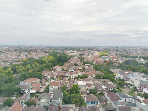an aerial view of a city with houses at Room 88 Kemang View Apartment Tower Flamboyant in Pekayon Satu