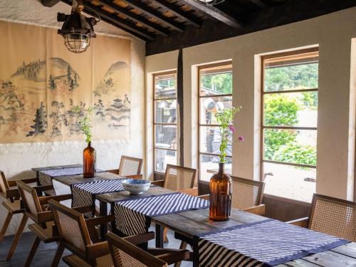 two tables in a room with chairs and windows at LATERAL - Vacation STAY 36594v in Shiojiri