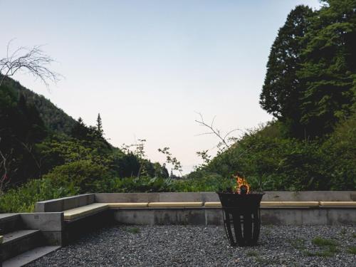 a vase with a fire in it sitting on some rocks at LATERAL - Vacation STAY 36594v in Shiojiri