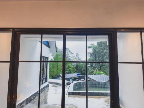 a view from a window of a pool at Arunika Villa in Ciloto