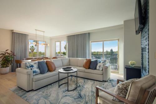a living room with a couch and a table at The Westin Sacramento Riverfront Hotel & Spa in Sacramento