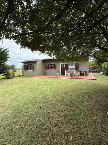 a house with a lawn in front of it at Casa Mar de Cobo in Mar de Cobo
