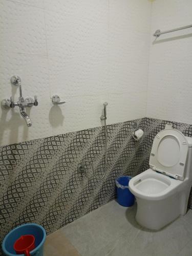 a bathroom with a toilet and a sink at Pokhara Metro Eco Hotel in Pokhara