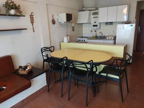 a kitchen with a table and chairs in a room at Amanecer mensajero in San Bernardo