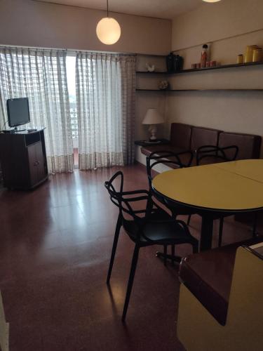 a living room with a table and chairs and a television at Amanecer mensajero in San Bernardo
