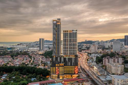 a tall skyscraper in the middle of a city at Iconic Regency Service Residences, managed by Iconic Hotel in Bayan Lepas