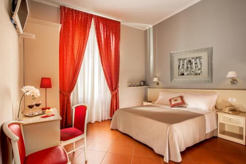 a bedroom with a bed and a red chair at Ottaviano Guest House in Rome