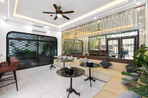 a lobby with a couch and tables and a ceiling fan at Khách sạn Phố cổ Hotel Ninh Bình in Ninh Binh