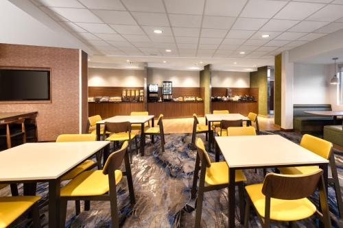 a dining room with tables and yellow chairs at Fairfield Inn & Suites by Marriott Moncton in Moncton