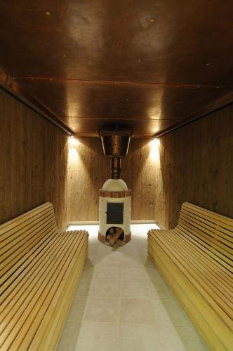 two beds in a sauna with a tv in it at The Library Hotel Wellness Retreat in Kalavasos
