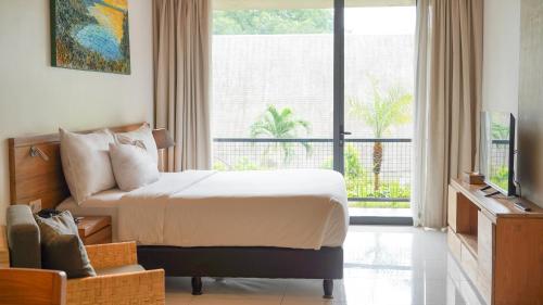 Voodi või voodid majutusasutuse Nagomi Suites & Hotel toas