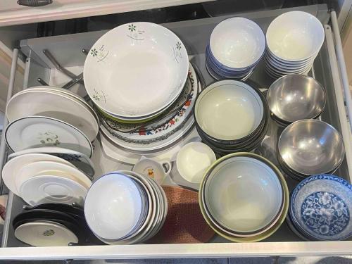 a drawer full of dishes and bowls and plates at 溪南秘境-XiNan hideaway in Wuri