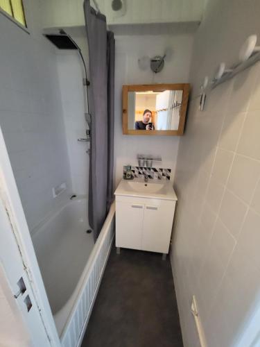 une personne prenant une photo d'une salle de bains dans l'établissement AU VAL BENOÎT chez sylvain, à Allos