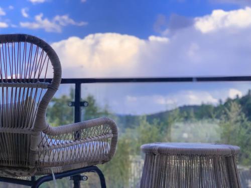 a wooden chair sitting on top of a balcony at Kunming Mountain Wowo Hefeng Dieyuan B&B in Kunming