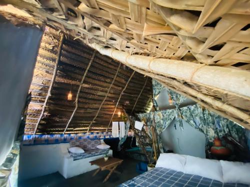 a room with a bed and a wooden ceiling at The Forest Edge Resort in Dambulla