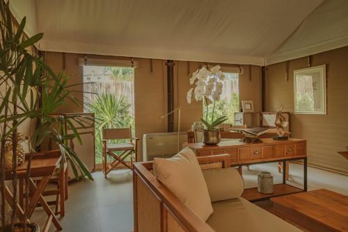 a living room with a desk and a couch at Twinpalms Tented Camp Phuket in Bang Tao Beach