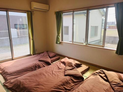 Postel nebo postele na pokoji v ubytování Nest Kisarazu