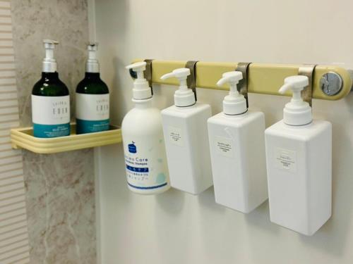 a group of four bottles of soap on a shelf at Nest Kisarazu in Kisarazu