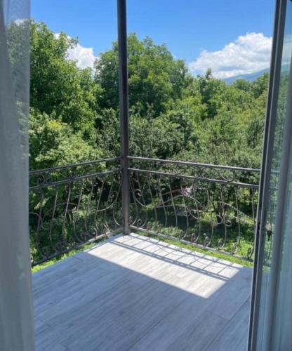 a room with a balcony with a view of trees at Dream Home in Vanadzor