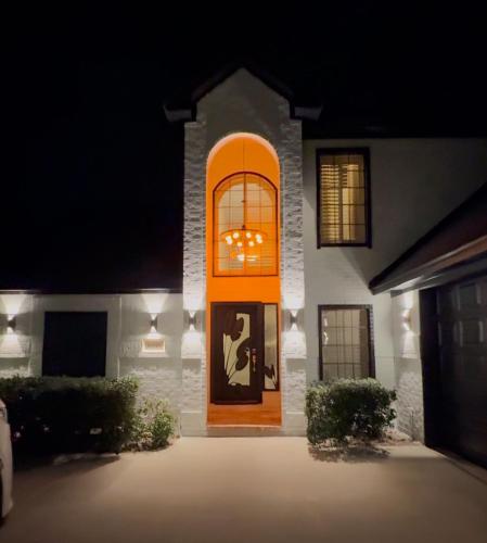 a house with an orange door at night at Lakefront Oasis in Humble