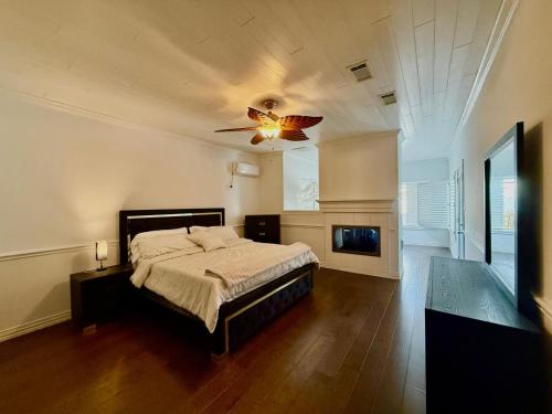 a bedroom with a bed and a ceiling fan at Lakefront Oasis in Humble