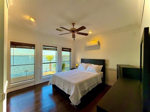 a bedroom with a bed and a ceiling fan at Lakefront Oasis in Humble