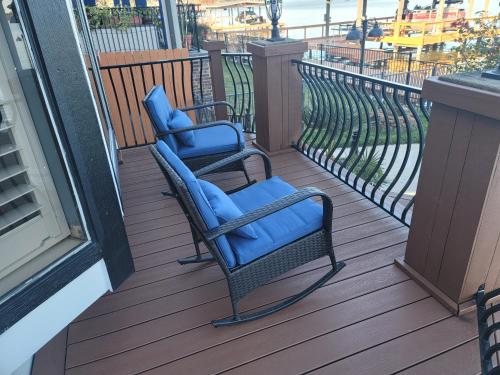 two blue chairs sitting on a deck on a balcony at Lakefront Oasis in Humble