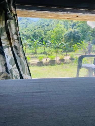 a window in a room with a view of a field at The Forest Edge Resort in Dambulla
