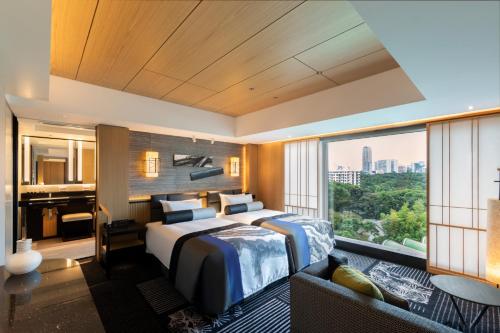 a hotel room with a bed and a large window at Hotel New Otani Tokyo The Main in Tokyo