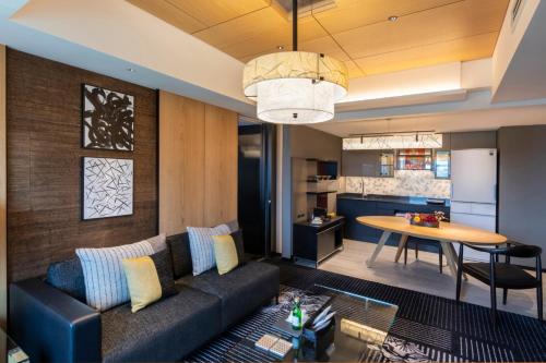 a living room with a couch and a table at Hotel New Otani Tokyo The Main in Tokyo