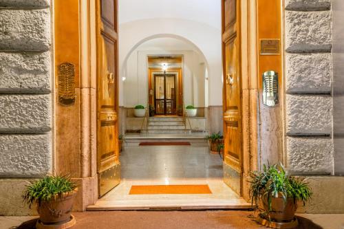 a hallway of a building with two potted plants at Ottaviano Guest House in Rome