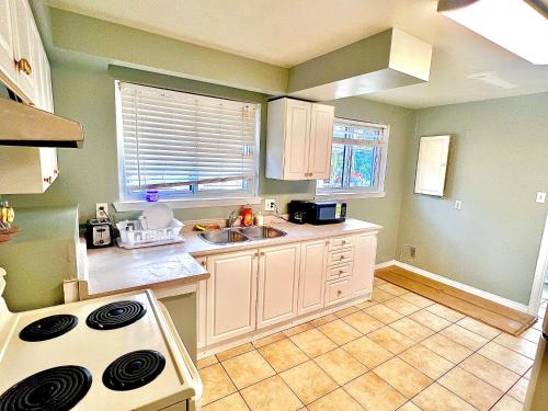 a kitchen with a sink and a stove at Dar-09 Room Near Airport in Brampton