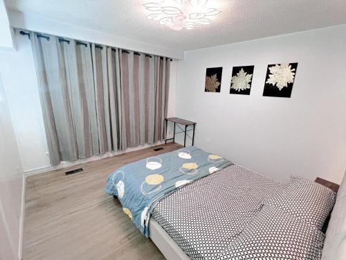 a bedroom with a bed and a large window at Dar-09 Room Near Airport in Brampton