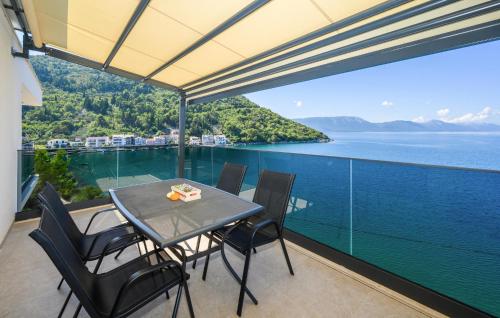 a table and chairs on a balcony with a view of the water at Stunning Home In Blace With Wifi in Blace