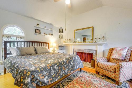 a bedroom with a bed and a chair and a fireplace at Lakefront Family Home with Dock in Newport! in Newport