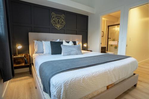 a bedroom with a large bed with blue pillows at Grotto Canyon Chalet in Canmore