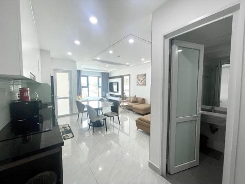 a kitchen and living room with a table and chairs at Duc's Nha Trang Oceanus Apartment in Nha Trang