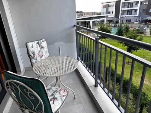 a patio with a table and chairs on a balcony at d’Pinx Nest in Gaborone
