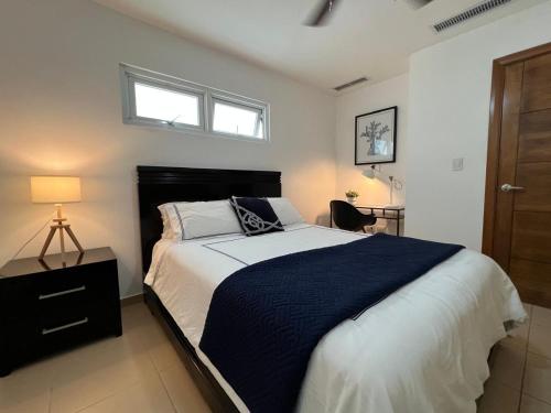 a bedroom with a bed with a black and white comforter at Marbella-SeaView-FrontBeach-Cozy-2Br-2Bds-4Pax-WiFi in Villas del Mar
