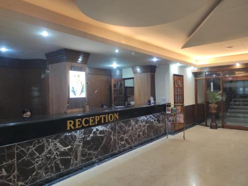 a lobby with a reception desk in a building at Hotel Ambarish Grand Residency in Guwahati