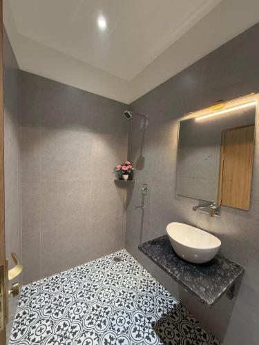 a bathroom with a sink and a counter with a mirror at Radhe Krishna Residency Nearest Triveni Sangam in Prayagraj