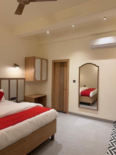 a bedroom with a bed and a mirror at Radhe Krishna Residency Nearest Triveni Sangam in Prayagraj