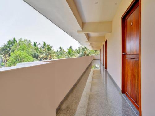 an empty corridor in a building with a window at Family Castle Hotel in Trivandrum