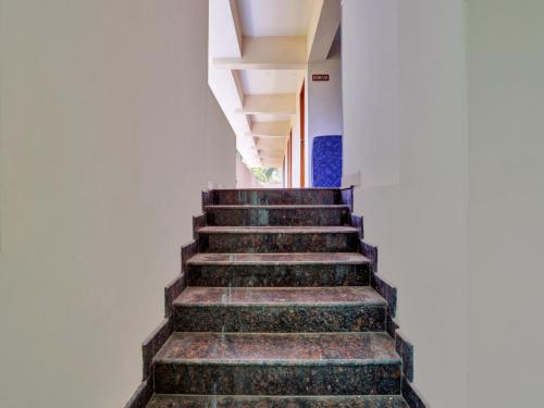 a set of stairs in a white building at Family Castle Hotel in Trivandrum