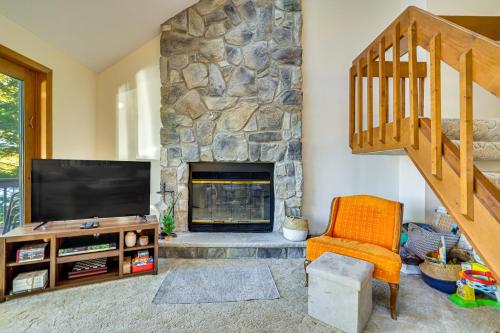 a living room with a fireplace and a television at Walk to Beach Arrowhead Lake Home in Pocono Lake