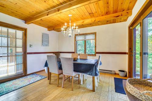 a dining room with a blue table and chairs at Walk to Beach Arrowhead Lake Home in Pocono Lake