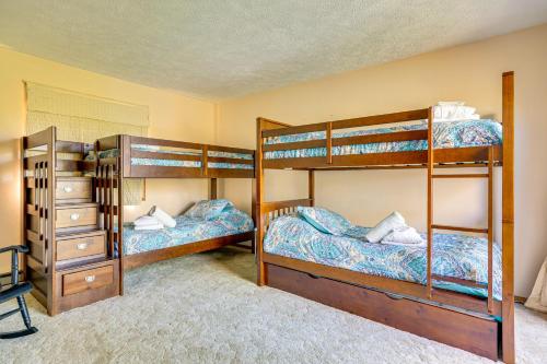 a bedroom with two bunk beds and a dresser at Walk to Beach Arrowhead Lake Home in Pocono Lake