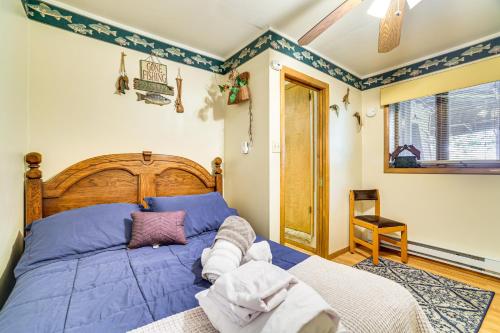 a bedroom with a large bed with blue sheets at Walk to Beach Arrowhead Lake Home in Pocono Lake