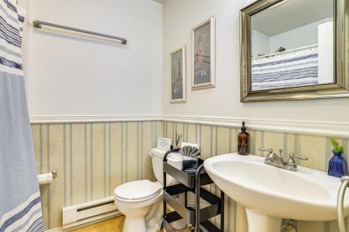 a bathroom with a sink and a toilet and a mirror at Walk to Beach Arrowhead Lake Home in Pocono Lake