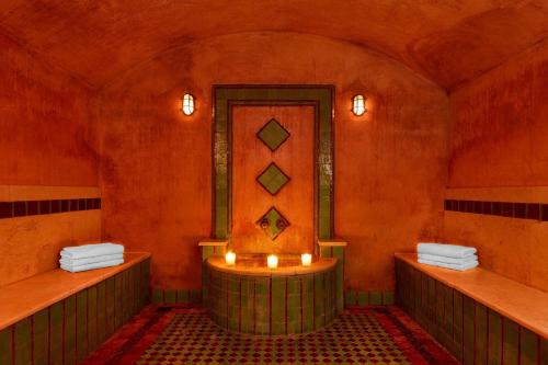 a room with a bath tub with candles in it at Le Meridien N'fis in Marrakech